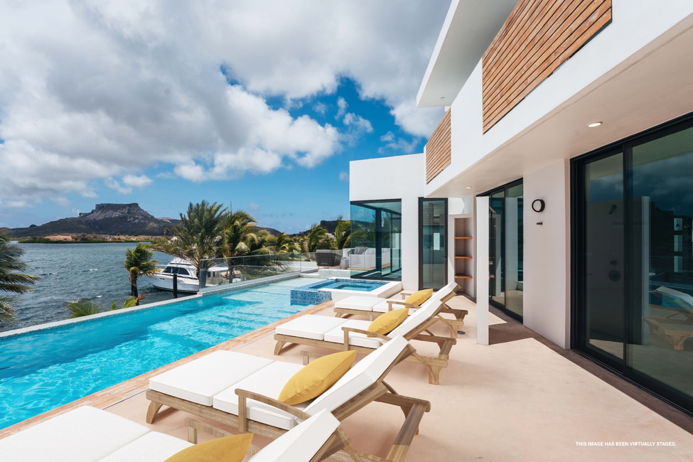 The multi level swimming pool with jetted tub and outdoor furniture, virtually staged.