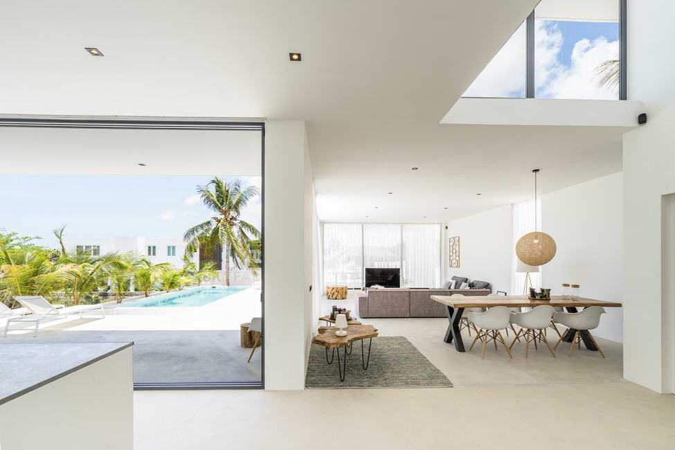 The grand sliding doors take the outside into the open stylish living space providing pool views.