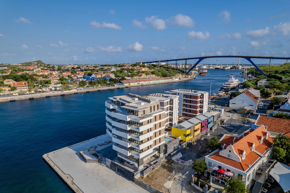 The Wharf's current stage of construction with the Queen Juliana bridge in the background. Image captured in February 2024.