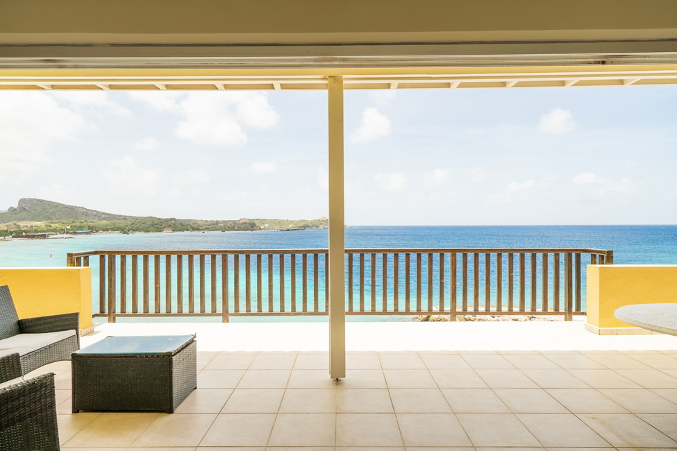 Give on to the whimsical view from the grand balcony over Caracasbaai bay in Curacao.