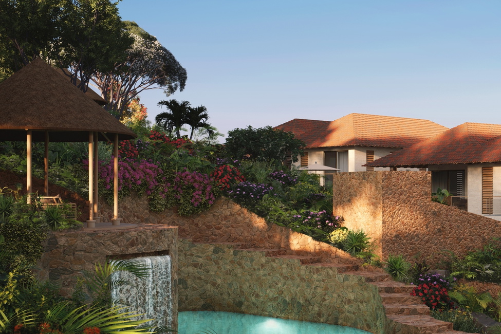 The lush, designed landscaping surrounding the communal swimming pool featuring waterfall and palapa of Blue Bay Hills Residences located in Blue Bay.